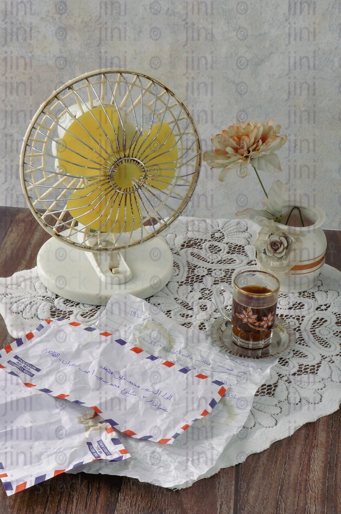 Crumpled vintage letters, coffee, vase,and fan