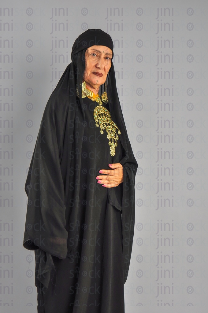 An upper Egypt woman or a woman from the Egyptian countryside putting her hand on her stomach or suffers from stomach or abdominal pain