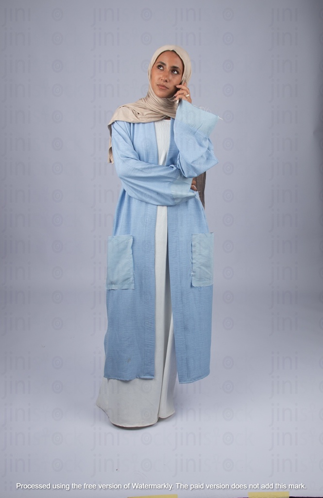 khaliji arab saudi woman from gulf standing thinking and talking on the phone