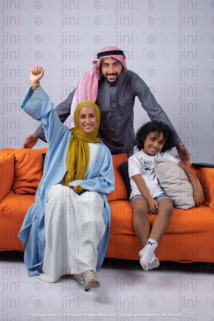 Khaliji saudi arab gulf family father son and mother happy on a couch