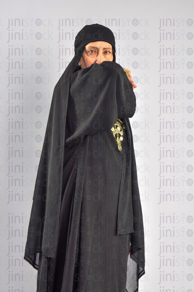 A sick upper Egypt woman or rural woman from the Egyptian countryside sneezing and has flu or cold