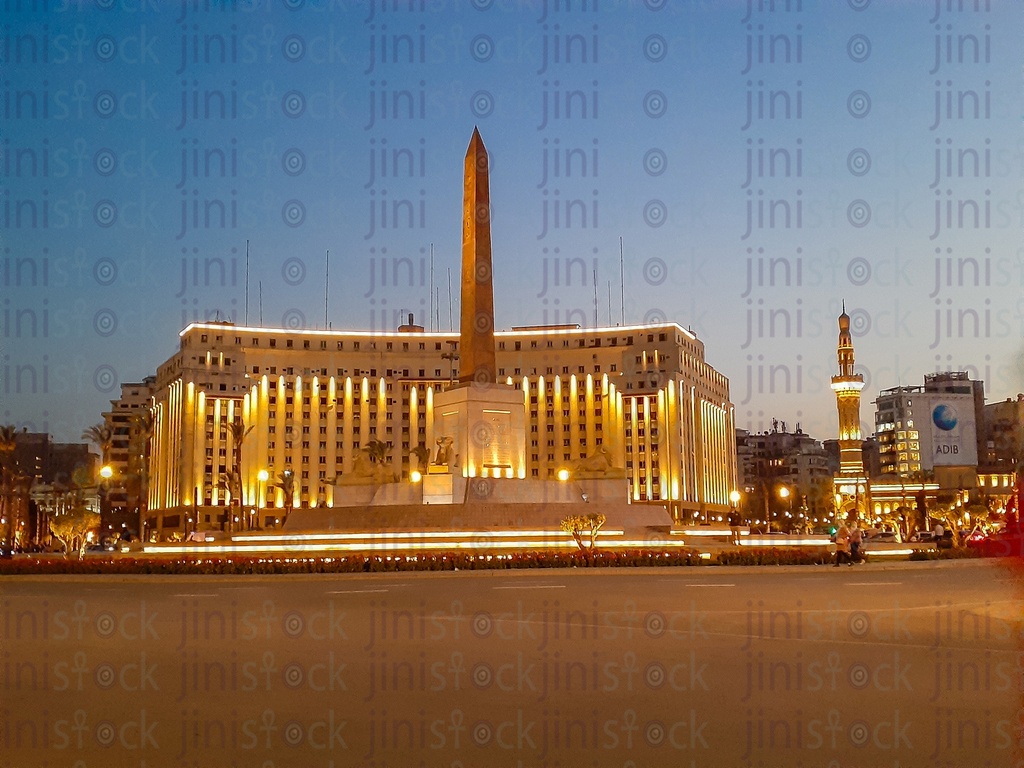 The obelisk, Rams, Tahrir Complex, Omar Makram Mosque in Tahrir Square, Cairo, Egypt at night, and the Street was empty of cars, use as a background for designs on Cairo streets.