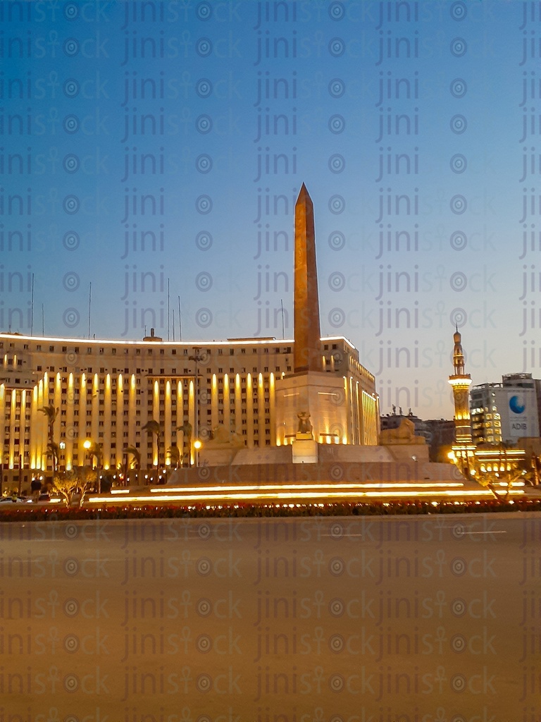 The obelisk, Rams, Mogamaa Al Tahrir and Omar Makram Mosque , in Tahrir Square, Cairo, Egypt at night, and the Street were empty of cars, use as a background for designs on Cairo streets.