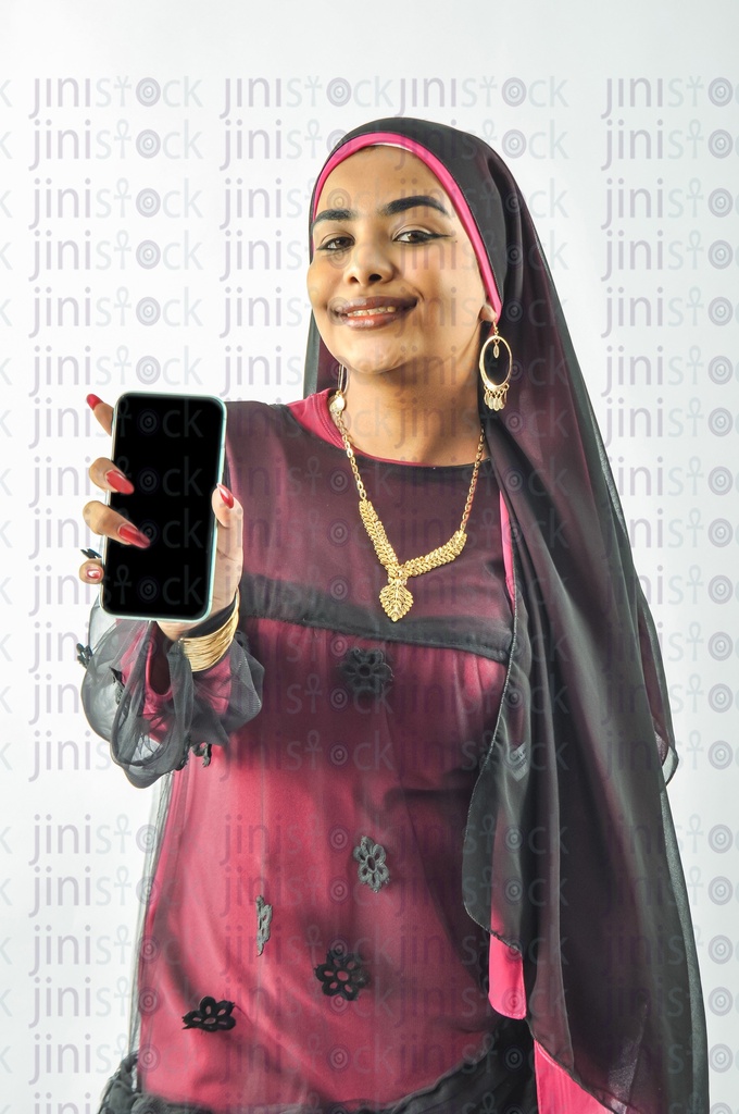 A Nubian woman from Egypt wearing Nubian clothes and holding a mobile phone in her hand and recommending an mobile application