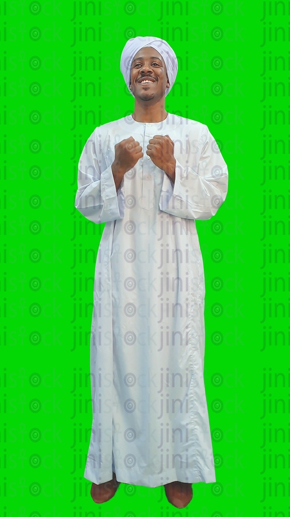 A Nubian Egyptian man or an upper Egyptian man wearing a galabia, happy and doing the winner sign