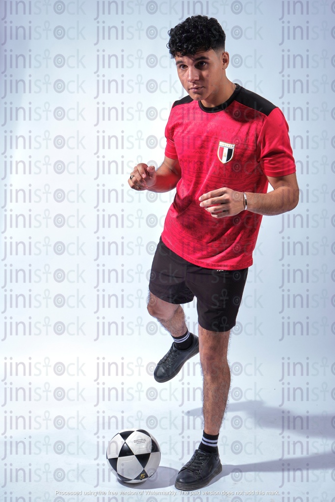 egyptian football fan wearing national football shirt and kicking ball