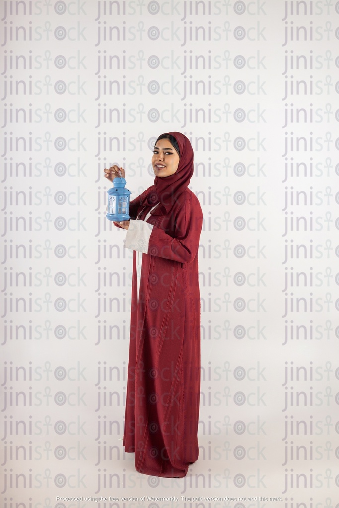 a stock image of a khaliji woman carrying Ramadan lantern on isolated background