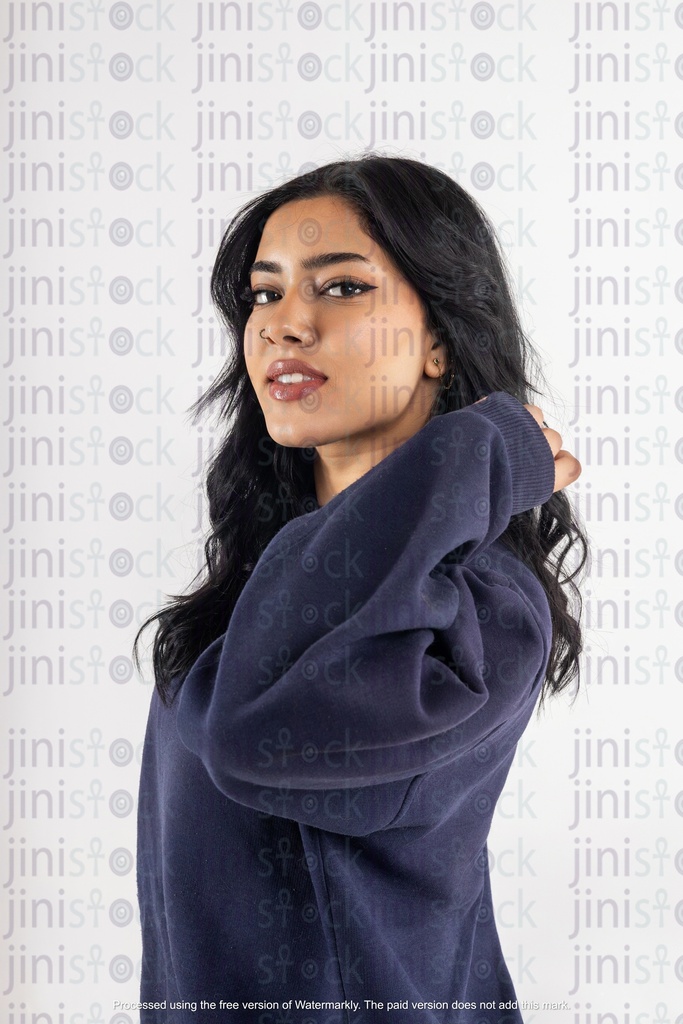 a stock image of a side Arabian woman with hands on hair on isolated background 