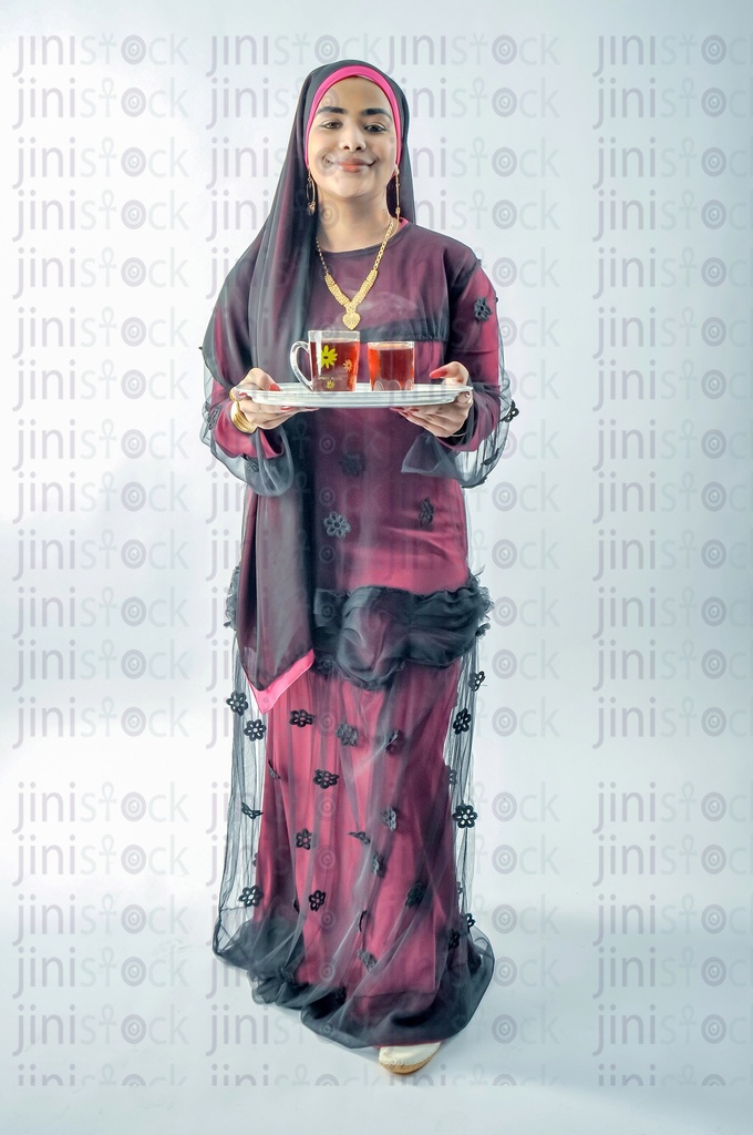 A Nubian Egyptian woman wearing a Nubian dress, a veil on her head, or an Egyptian farmer holding a tray of tea cups.