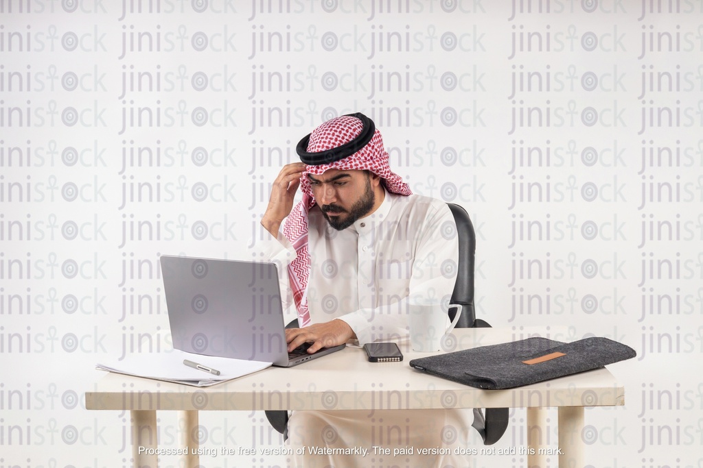 khaliji man working on his laptop stock image