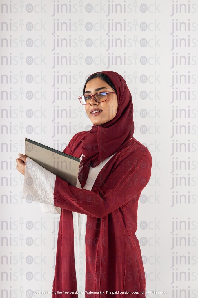 saudi khaliji working from gulf holding a notepad and looking to the camera