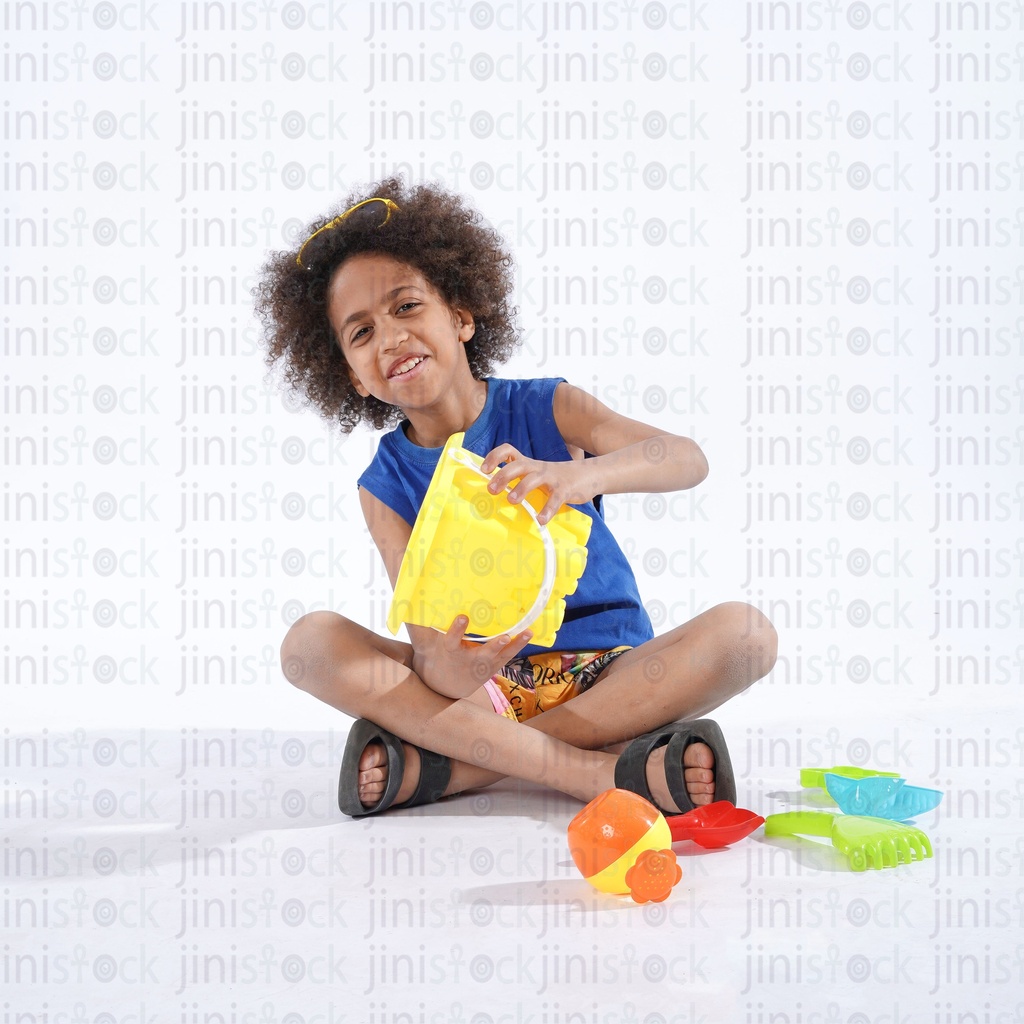 little boy playing with sand beach toys