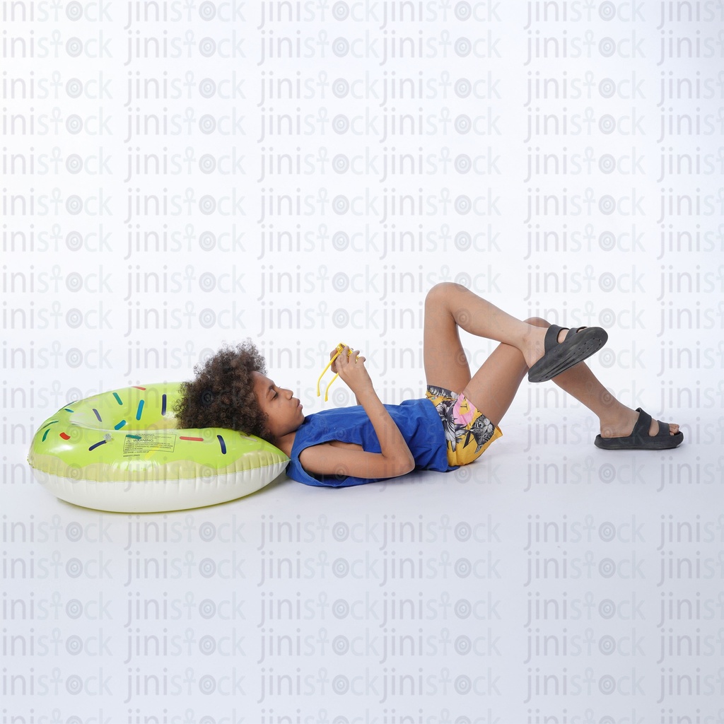 little egyptian boy sleeping on his back and  his head on a water floater