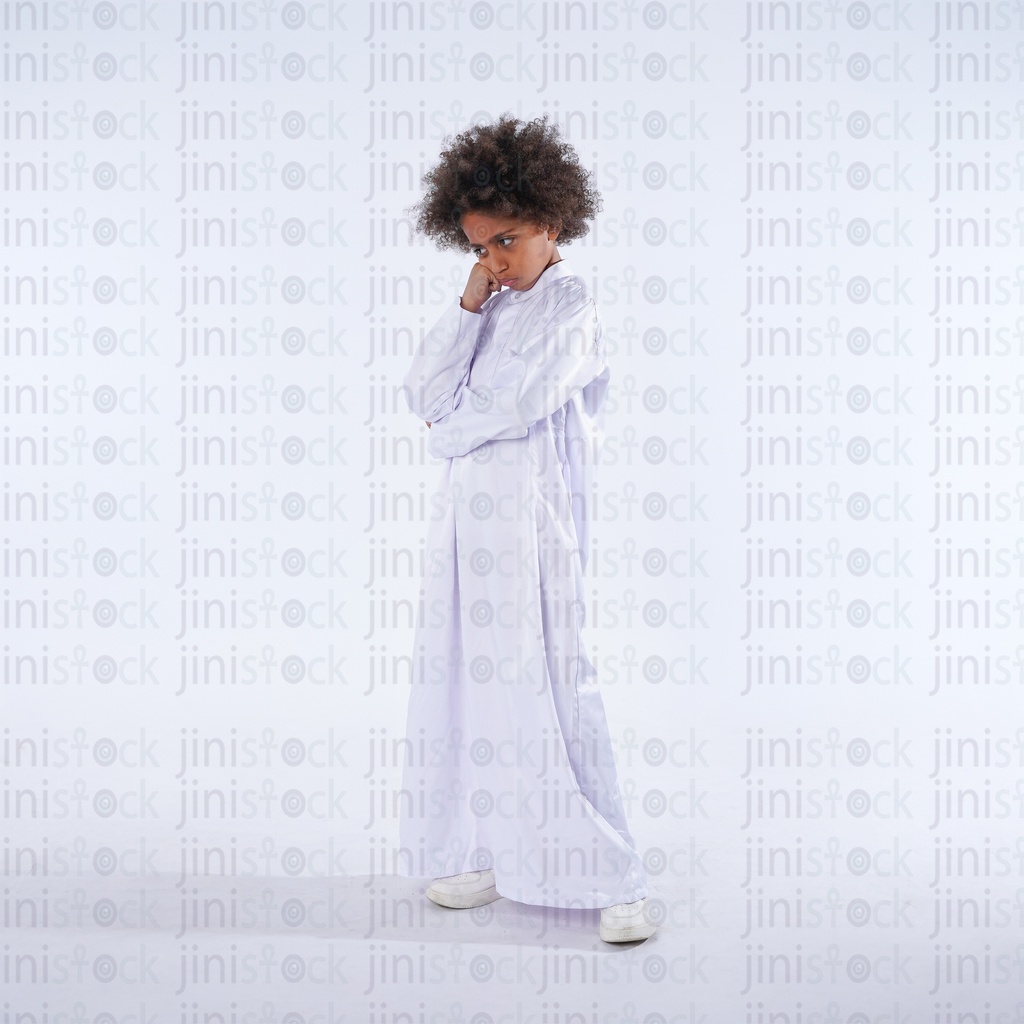 khaliji boy with curly hair from saudi gulf standing sad