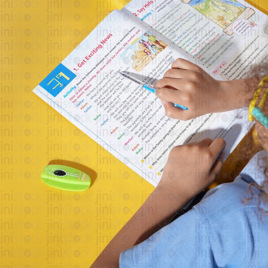 over the shoulder view  boy studying on a school book