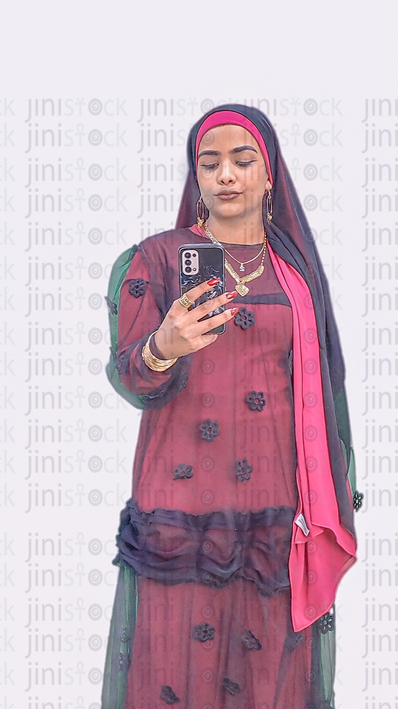 An Egyptian farmer or A Nubian girl wearing a Nubian outfit holding a mobile phone & texting or browsing an app