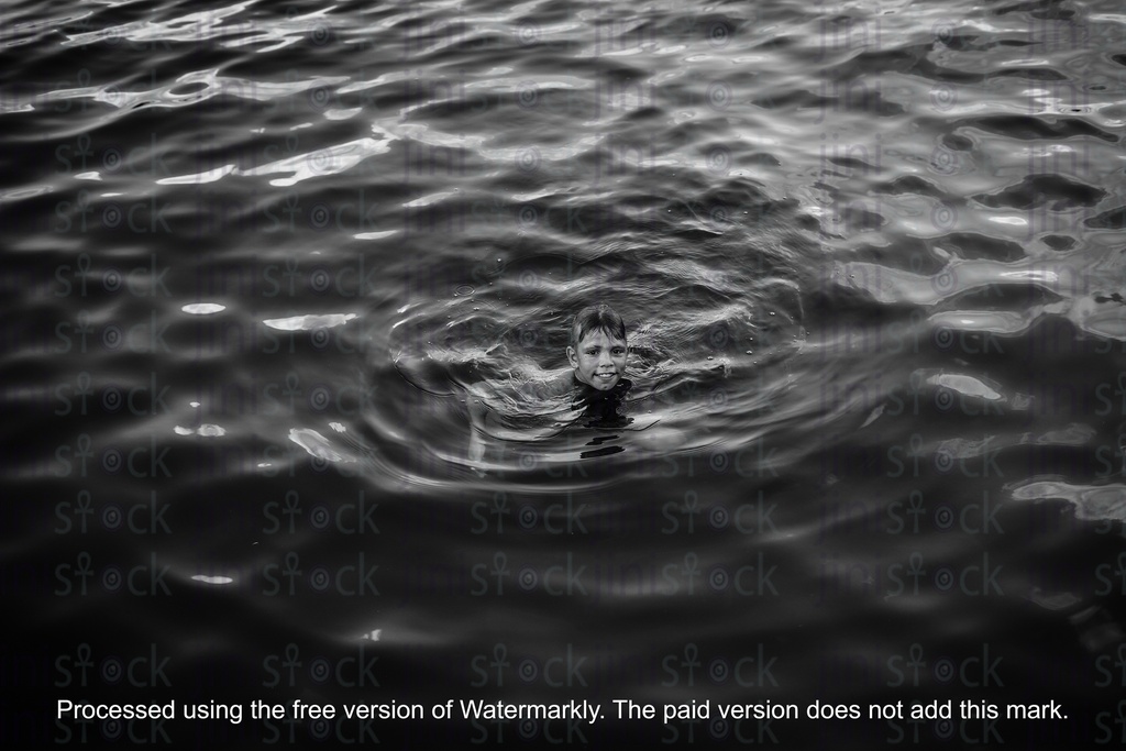 egyptian boy swimming in the nile in black and white