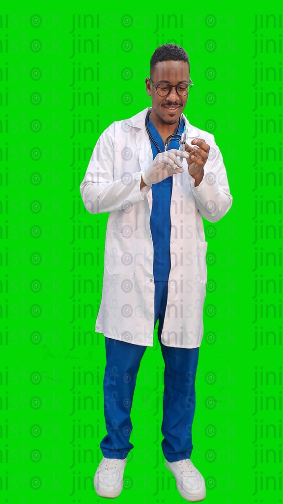 Egyptian or Sudanese doctor or physician wearing a white coat and stethoscope and preparing a syringe or an injection