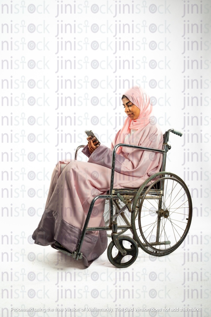 saudi khaliji woman on a wheelchair and working checking her mobile
