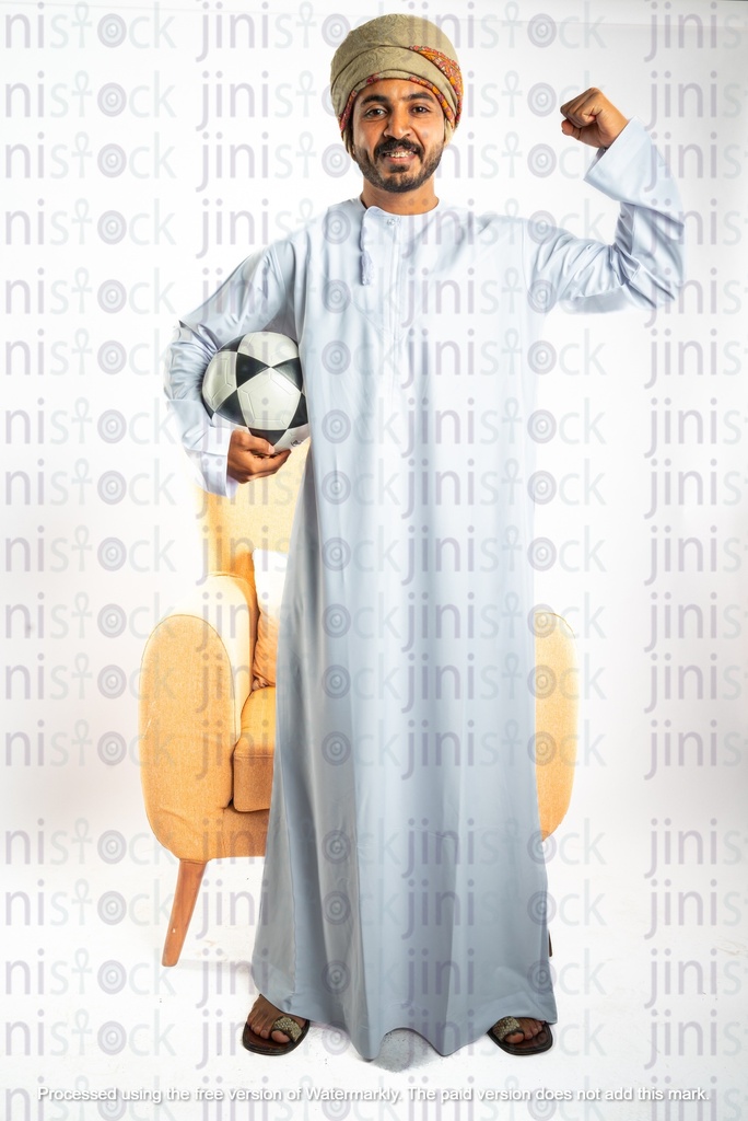 omani from oman khaliji man from gulf sitting on a chair with football under his arms