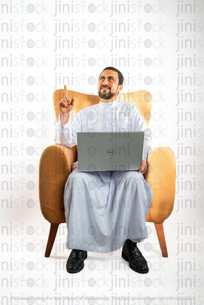 saudi khaliji man sitting on a chair and with a laptop on his leg and pointing up