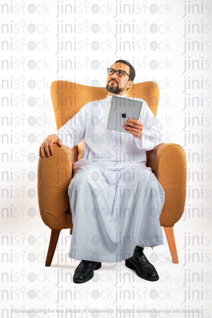 saudi khaliji man sitting on the chair holding ipad and thinking working