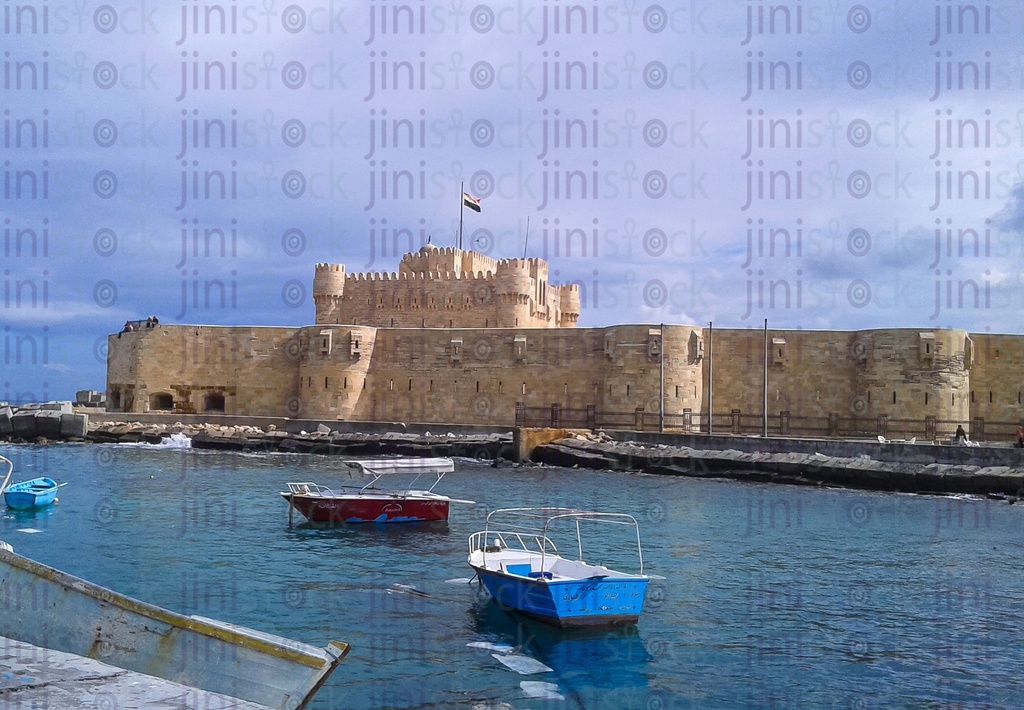 Qaitbay Castle in Alexandria and the Sea of Alexandria and boats in it.