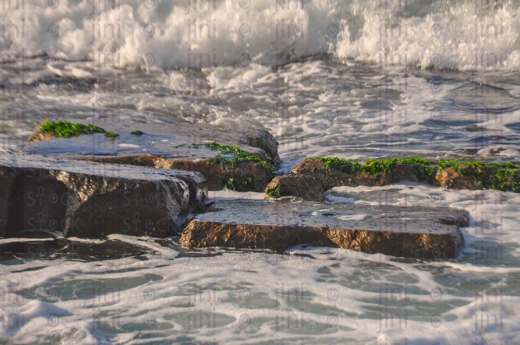 A beach, water splash and waves in Alexandria- Alexandria Corniche beach at sunset.