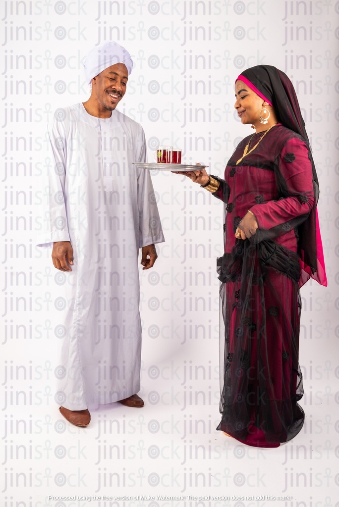 Nubian Egyptian man and woman serving tea on a tray
