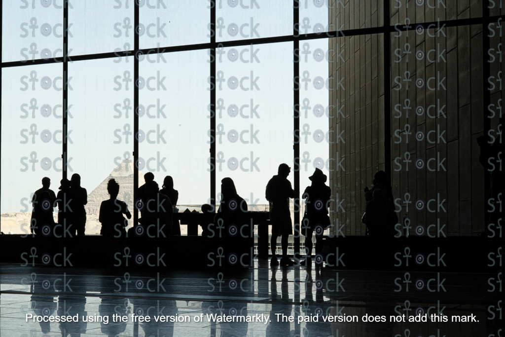 Tourists view the pyramids from inside the new Egyptian Museum