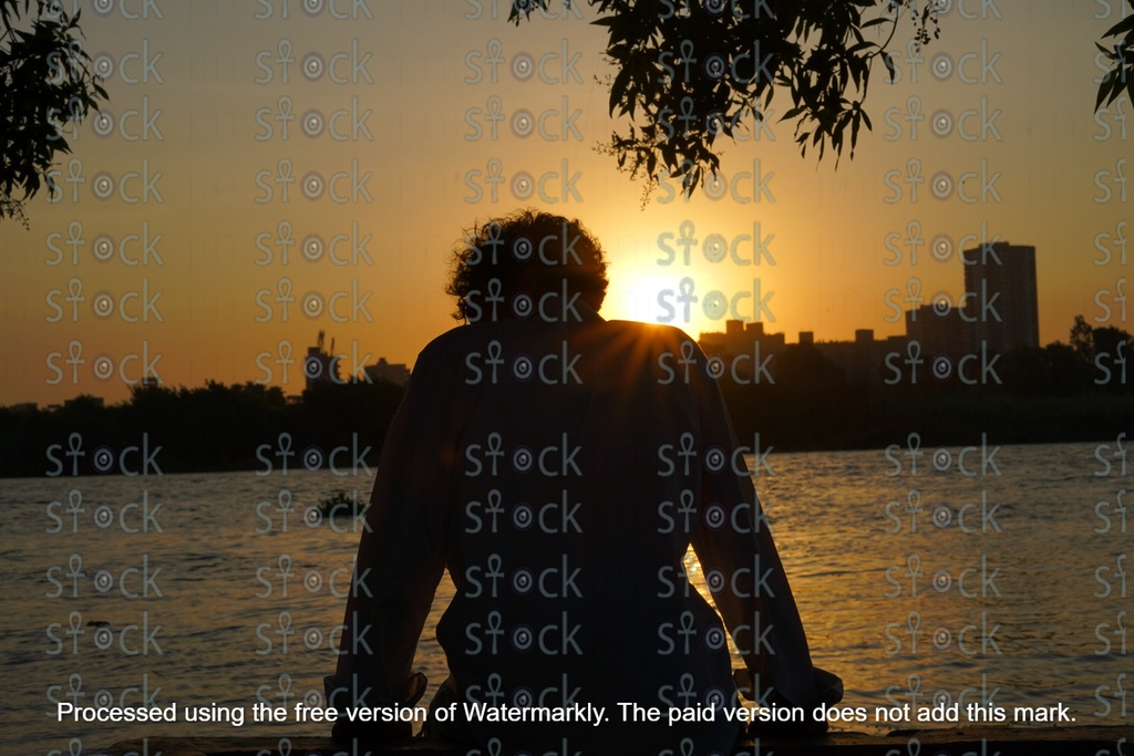 young man contemplating sunset