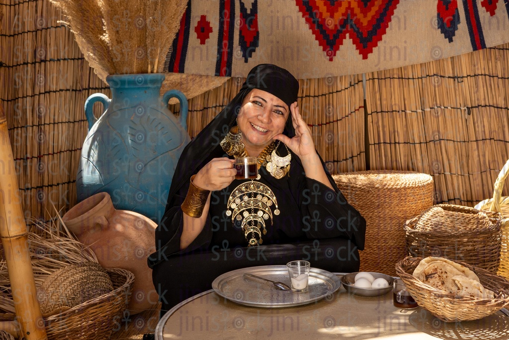 Bedouin woman drinking tea after breakfast