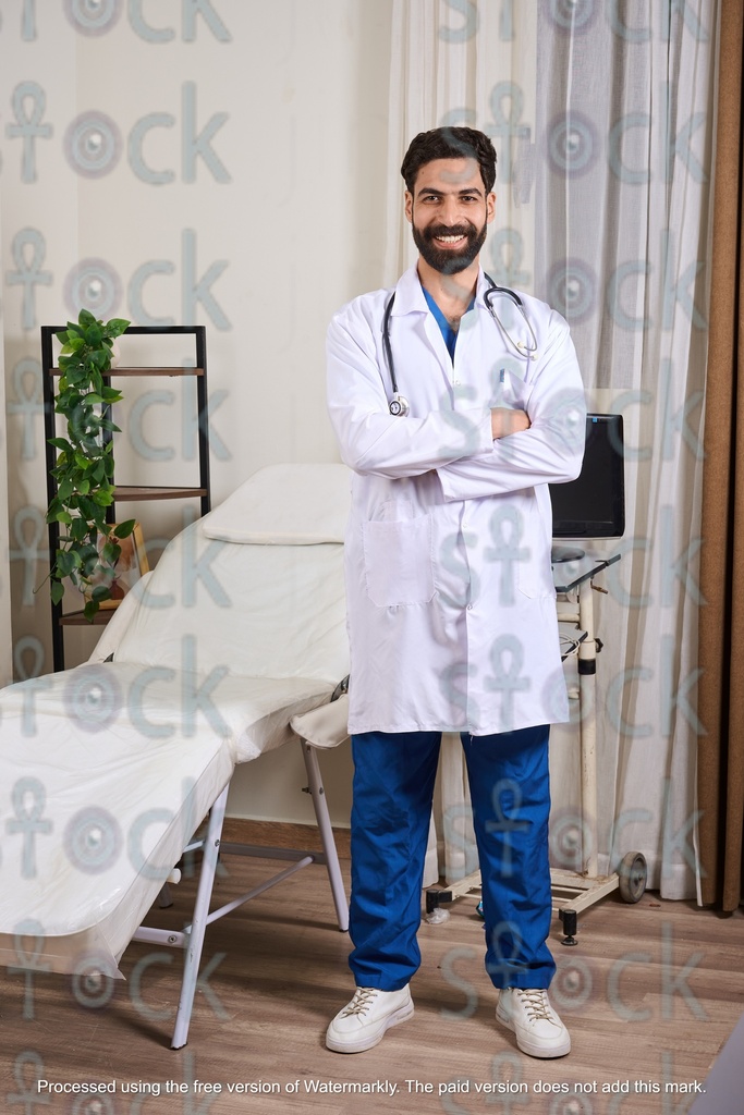 smiling doctor standing wearing medical coat and stethoscope