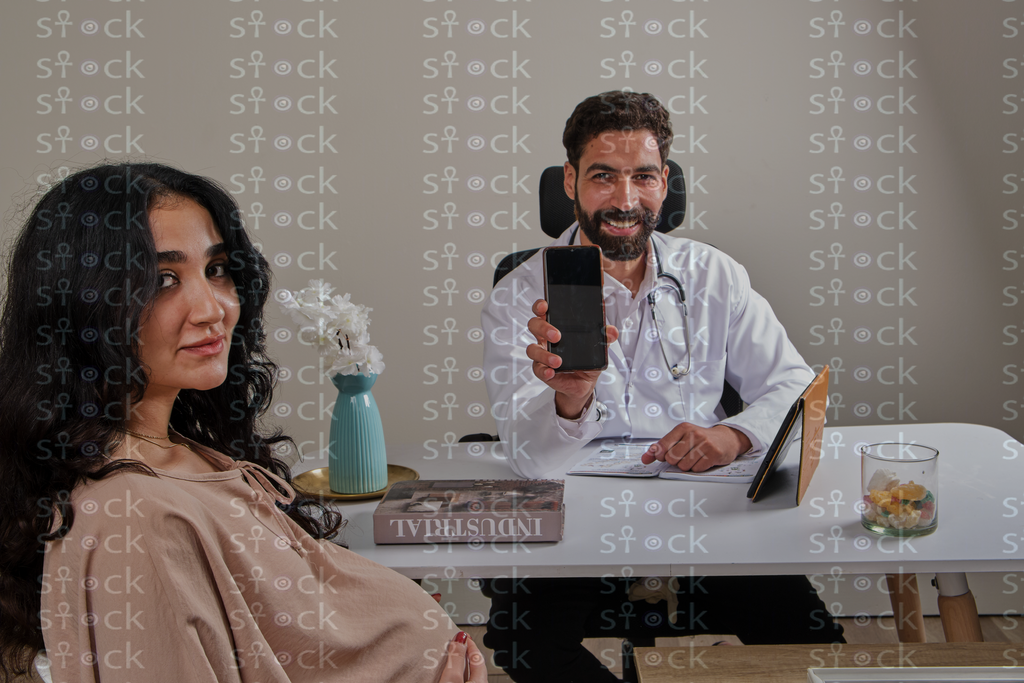 Doctor showing phone to patient