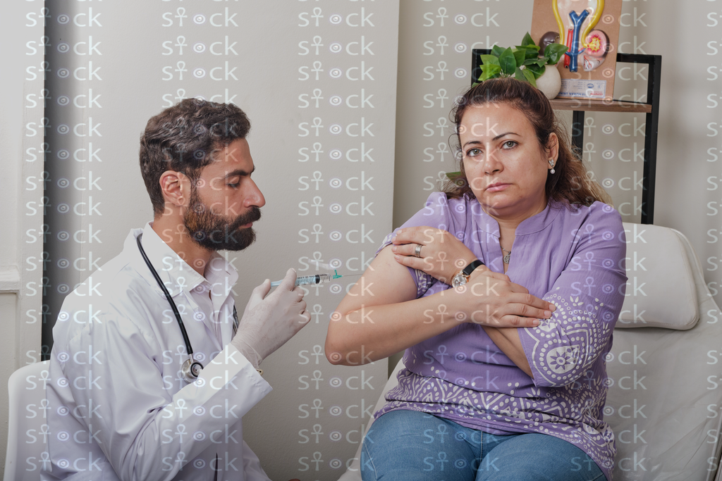 Doctor preparing to give injection 