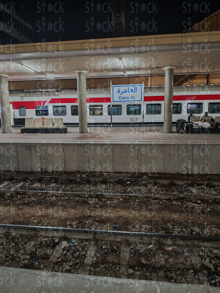 Red and White Train Under the Station Lights 