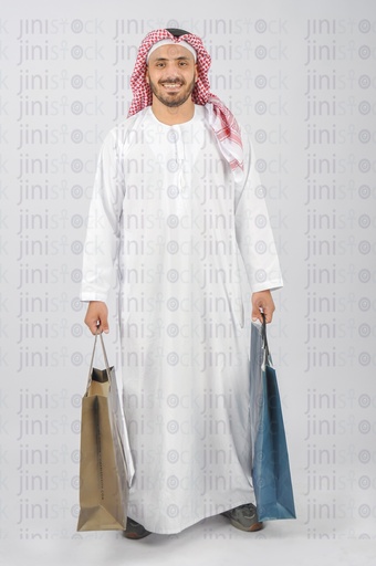 Saudi or Emirati or Khaliji man holding his shopping  bags