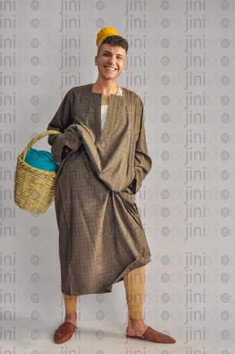 An Egyptian farmer holding a basket in his hand.