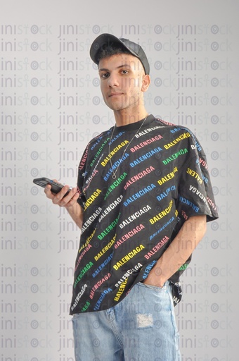 An Egyptian cool man holding a mobile phone. " summer vibes"