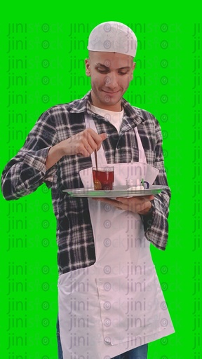 A video of a man holding a tray of tea and sugar and he is stirring the tea  in his hand and wearing work clothes for a coffee shop or café