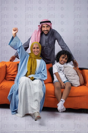 Khaliji saudi arab gulf family father son and mother happy on a couch