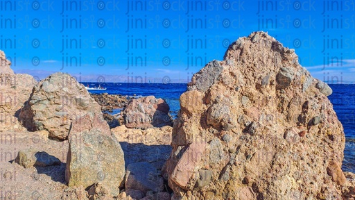 A Beach, rocks, and mountains in Dahab, south Sinai, Egypt.