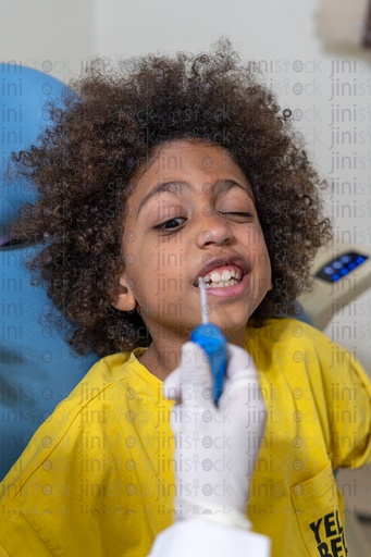 Little boy sitting on the dental chair scared of pain