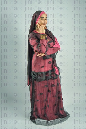 An Egyptian farmer girl or a Nubian woman from Egypt wearing Nubian clothes and putting her hand on her cheek