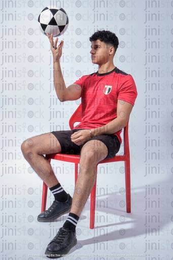 egyptian man wearing the egyptian national football team shirt and rotating a foot ball on his finger