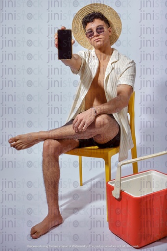 young Egyptian man holding a mobile and sitting  wearing summer out fit