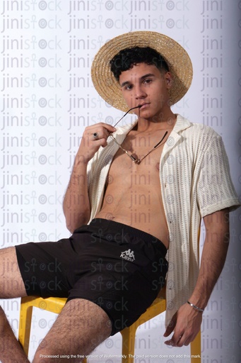 egyptian man sitting on a chair on the beach wearing summer cloth