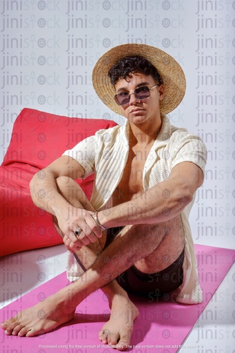 Egyptian man sitting on a mat on the beach in summer