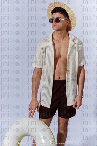 Egyptian man walking on beach holding water floater