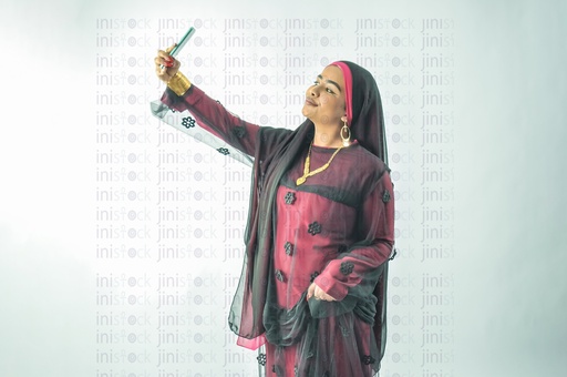 A Nubian Egyptian girl wearing Nubian clothes taking selfie photo